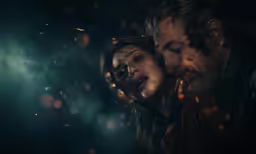 man and woman are surrounded by a fire