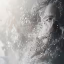 a person looking through a window with snow in the window