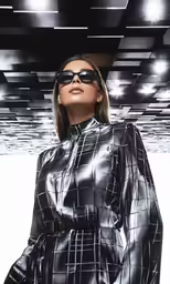a woman wearing sunglasses with black and white pattern