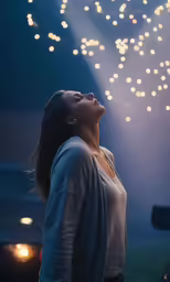the girl stands under a canopy looking up at fireworks