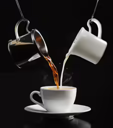 coffee being poured into a cup with saucer