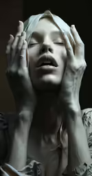 a woman wearing white holding her hands up to the side