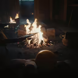a fire blazing in the open on a dark night