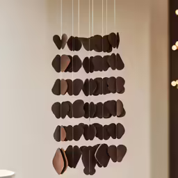 a group of heart shaped paper shapes hanging from strings