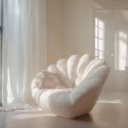 a woman sitting on top of a white couch
