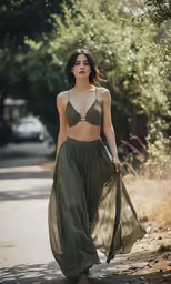 a woman walks down the street in a green bra top