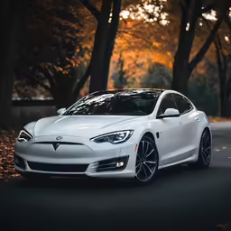 a very sleek white car parked in the middle of the road