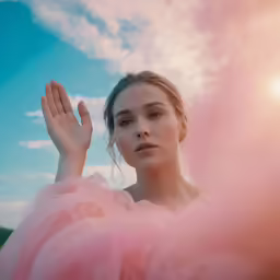 woman in dress and clouds and sky behind her