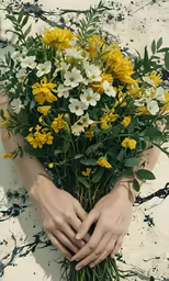 the hands on the bouquet of flowers are on the ground