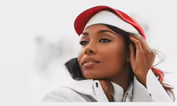 an attractive woman wearing a red and white santa hat