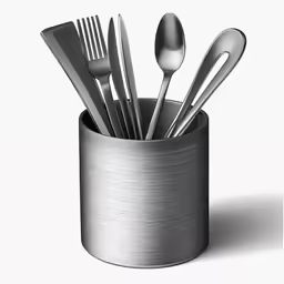 a cup filled with silverware sitting on top of a white counter