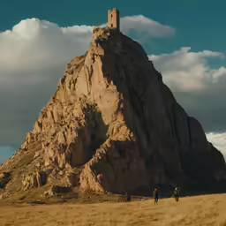 a big rock with a tower on top of it