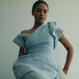 a woman is wearing an unusual blue gown
