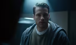 a man stands in a dimly lit room