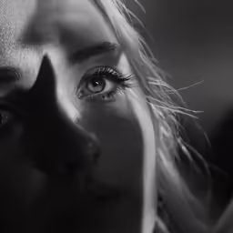 a woman has her eyes opened with hair on top