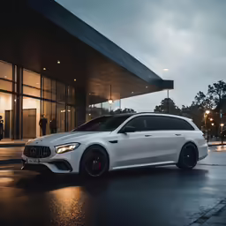 a white mercedes cla - class at night in front of a building