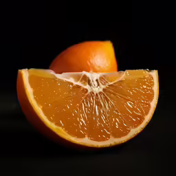 two halves of an orange in front of a black background