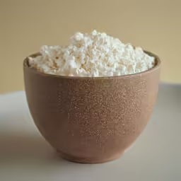 a bowl with a small amount of popcorn in it