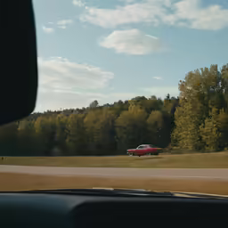 a red truck that is sitting in the grass
