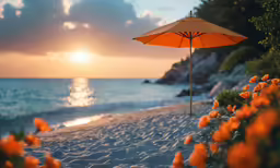 an umbrella is standing on the beach next to some flowers