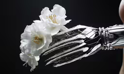 a robotic hand holding flowers, with the skeleton arm partially closed