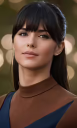 a model wears a brown turtleneck with her hair pulled back