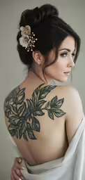 the back view of a woman with tattoos on her upper half