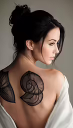 a woman with a black tattoo on her back