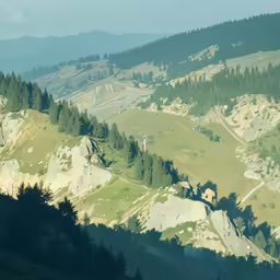 an overview of a green mountain with mountains in the distance