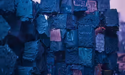 an arrangement of black plastic bricks with blue stains