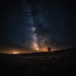a very dark sky full of clouds and some light pollution