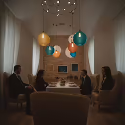 people in formal wear are sitting around a table