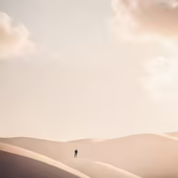 a lone person standing on the side of a large hill