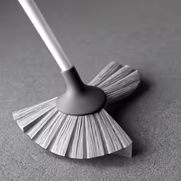 a large broom sitting on top of a gray carpet