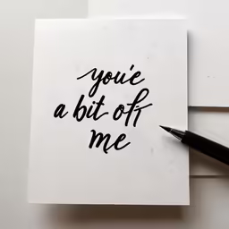 someone writes on a piece of paper with a pen