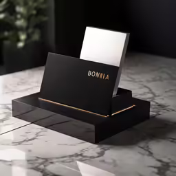 a black and white desk that has business cards on it