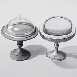 two silver cake plates on a white surface