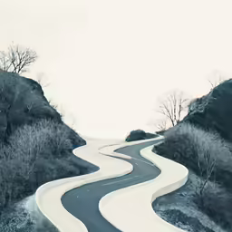 an image of a curve road going through the mountains