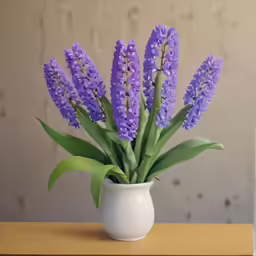 purple flowers are in a vase on a table