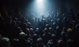 a crowd of people in the dark at a concert