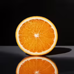 an orange cut in half on a table