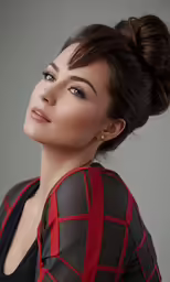 a beautiful young woman wearing a black dress posing for a portrait