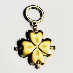 three leaf clover key ring with two keys,a close up of a gold metal keychain