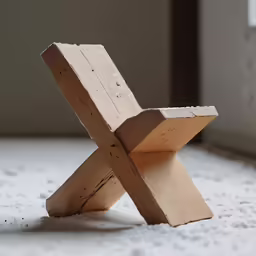 a wooden toy is laying on a rug