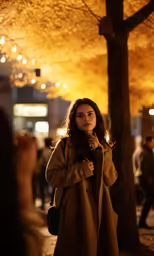a woman standing outside holding her hands to her face