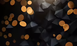 the image of gold colored lights on black background