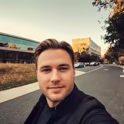 a man taking a selfie while standing on a street