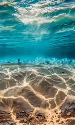 a photo of the ocean from underneath water, it is very clear