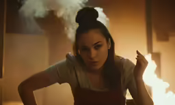 a woman in a white shirt smokes a cigarette