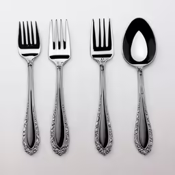 four silverware utensils are on the table